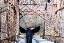 The Mothman standing on a bridge, looking spooky.