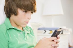 A kid texts while waiting for something. Kids fifty years ago didn't have texts